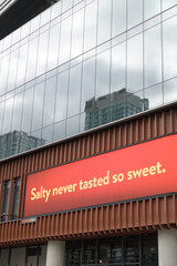 Naklejka premium digital billboard featuring a slogan: “Salty never tasted so sweet” associated with Ritz Crackers outside The Well, 486 Front St W, Toronto