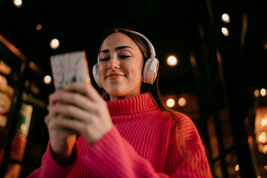 Pensive female professional looking away while holding digital tablet in cozy coffee shop, thoughtful freelancer dreaming of success and future goals, digital nomad vision, copy space.