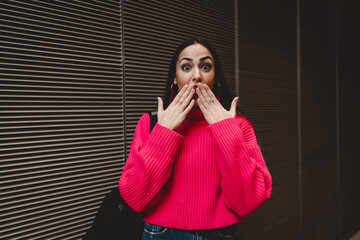 High angle view of focused young woman using digital tablet while sitting on modern building...