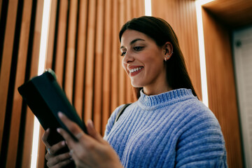 Happy woman using mobile phone app, browsing internet, digital lifestyle, 5G cellular connection,...