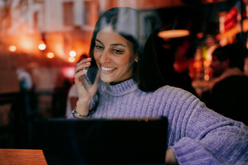 Happy lady holding digital tablet in stylish wooden interior background. Student learning online,...