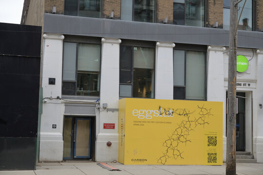 exterior building facade and sign box for Eggslut and LA based breakfast sandwich chain located here at 545 King St W, Toronto