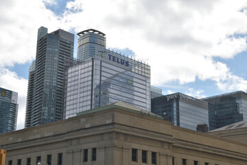 Naklejka premium looking southwest to Telus Harbour and skyline sign at 25 York St from Front St W and Bay St Toronto (contrast with Post Office Department building)