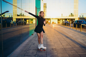 Naklejka premium Skater stands upright with one hand extended and headphones on, blending poised motion readiness with audio‑linked body flow, balanced coordinate action, and music‑led movement.