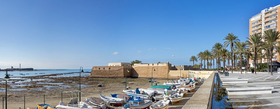 Panoramic view over Caleta beach and Santa Catalina castle in the old town of Cadiz, Spain, at low tide on a quiet day in winter