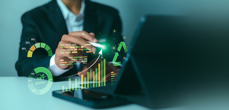 Net Zero emission carbon neutrality business concept.ESG environmental social and governance digital report.Green energy technology.Businessman analyzing ecological data on digital tablet.