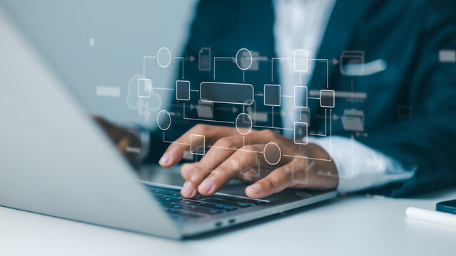 Business process workflow automation with digital flowchart interface.Digital transformation and IT system architecture optimization.Businessman analyzing complex organizational structure on laptop.