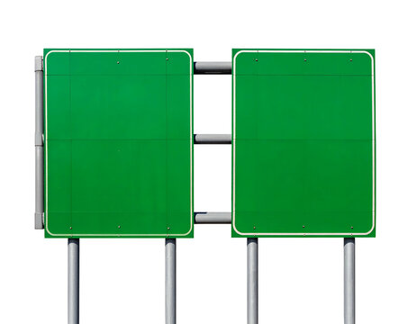 Two blank green highway signs on metal poles against a black background