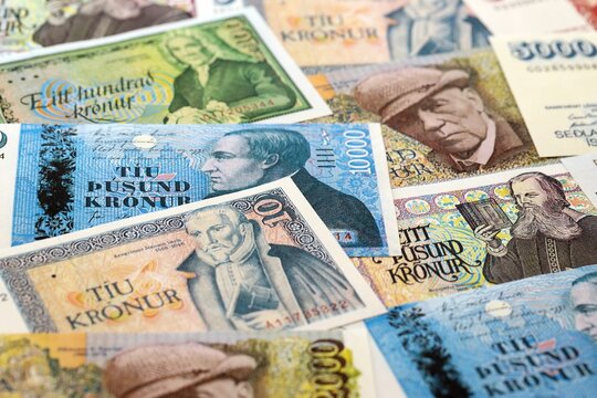 Icelandic krona money bills pile on table. Iceland banknotes of ISK currency close up. Concept of business, economy and banking in Iceland