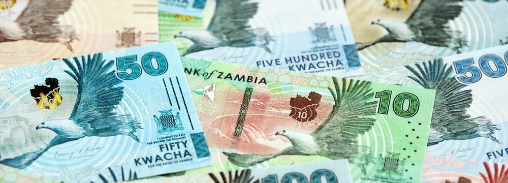 Zambian kwacha money bills pile on table. Zambia banknotes of ZMW currency close up. Concept of business, economy and banking in Zambia