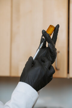 Woman extracting medicine from a vile