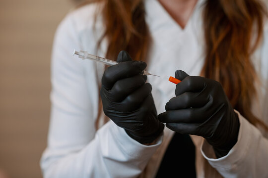 Woman holding a small syringe 