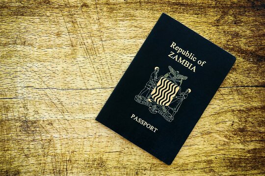 Zambian passport on table close up. Official identification document book for citizens of Zambia. Concept of travel and tourism in Zambia