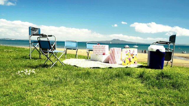 Serene view of a Sunny Beach Picnic Setup with View of Rangitoto Island. quintessential summer outdoor celebration in Auckland, New Zealand.