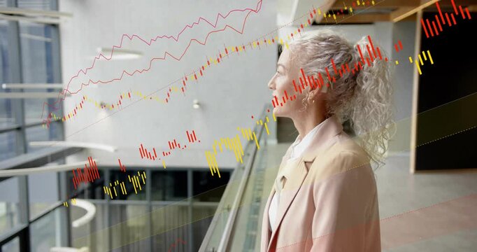 Exec at railing gazing atrium, data traces appearing and gradually obscuring profile for business