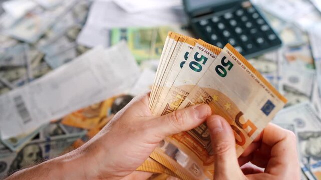 Man calculating money, monthly home expenses, taxes and bank account balance.