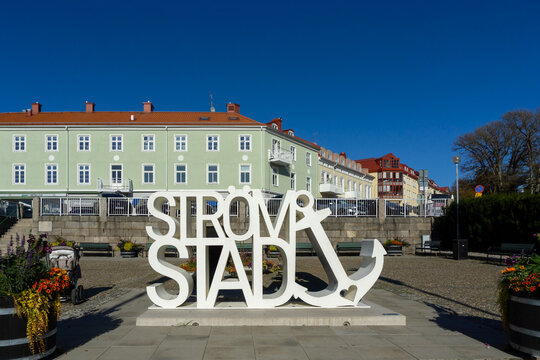 Stromstad, Sweden - September 21, 2019: City Landmark Sign with Anchor Sculpture in Town Square Featuring Historic Swedish Architecture and Coastal Town Charm under Clear Blue Sky