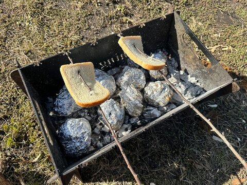 Bread strung on wooden sticks, baked on a grill
