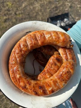 Top view of a plate with delicious grilled sausages