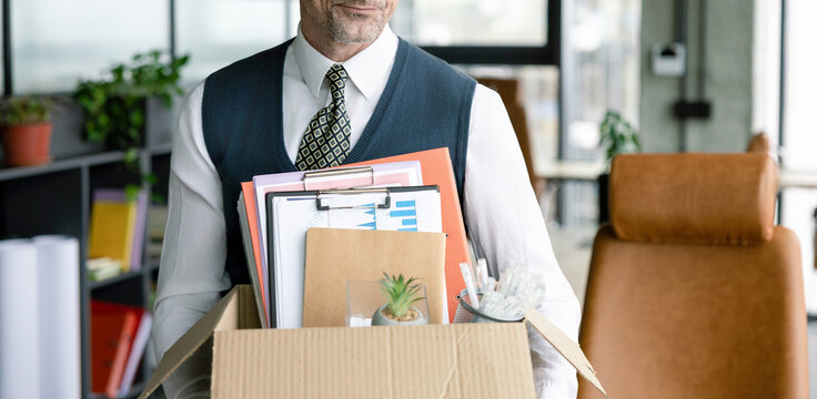Fired jobless employee. Unemployment crisis of man dismissed. Business man packing stuff. Last day at work. Upset office worker fired. Fired and unemployment with business man cropped view. Job loss