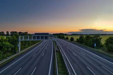 Empty German Autobahn Highway at Sunset with Gantry Sign - Leer - Transport - Landschaft - Autofrei - Highway - Road - Asphalt - Lines - Street - Route - Traffic - Travel - Ecology - Trail - Motorway © Enrico Obergefäll