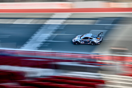 UAE, Dubai, 18 January 2026: 24h series racing supercars on the circuit, Battle of the teams, long exposure photography, supercars drive past at high speed, pitstops, training runs, watching people, 