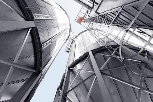 Industrial silos with steel framework and skyward perspective
