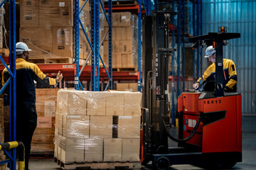 frican American warehouse worker raising hand to guide Caucasian forklift driver. Professional industrial team communicating for safe cargo pallet transport in distribution center. © ultramansk