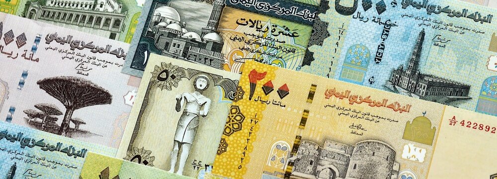 Yemeni rial paper banknotes pile on table. Yemen YER currency money bills in big amount. Concept of economics, taxation and banking in Yemen