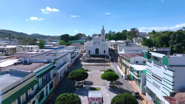 Aerial Drone footage the square and passing over Iglesia de Auxerre, San German, PR