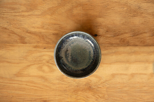 Blue ceramic bowl on a rustic wooden background