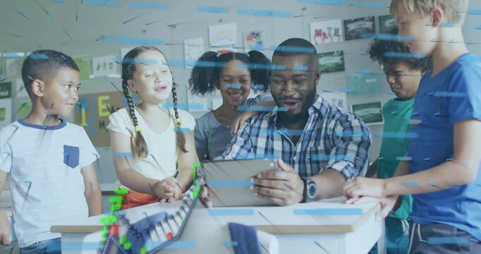 Male teacher in plaid shirt showing tablet while school kids leaning in class watching track model