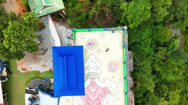 SI RACHA, THAILAND - MARCH 17, 2026: Aerial view of Samnaksong Khao Phra Khru Buddhist temple and monastery located on a hilltop overlooking the city.