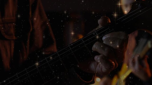 Foreground guitarist fretting while camera cutting closer, star overlay showing technique for music
