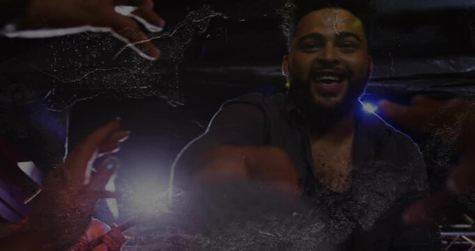 Vertical video: Lead singer offering mic as fans reaching inviting crowd singing under show lights