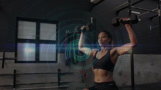 Woman sitting on bench pressing dumbbells, teal HUD and lens-flare initiating reps for fitness