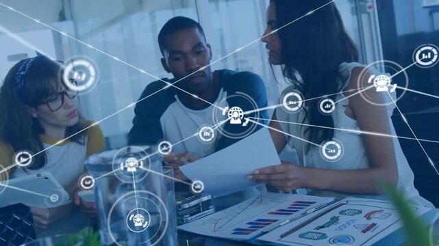 Marketing team reviewing graphs on tablet for planning, causing network nodes growing over table
