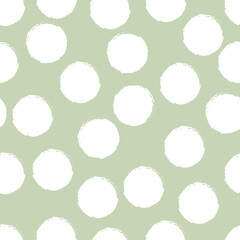 Seamless polka dot pattern with white circles on sage green background. © Diana