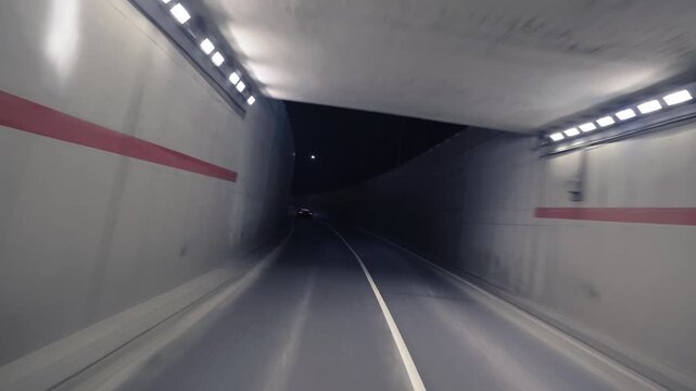 Rolling shot of black supercar driving at night underground tunnel, Monaco Monte Carlo 