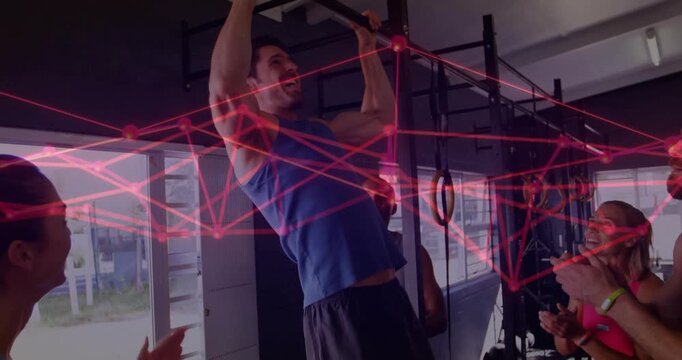 Man gripping pullup bar pulling up for strength, red overlay crossing gym rig, spotter steadying