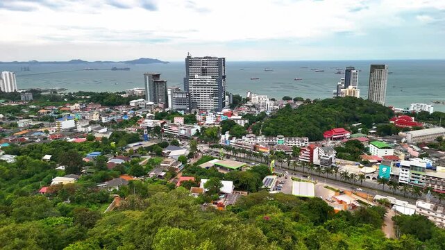 Drone flying over the urban landscape and coastal cityscape of Si Racha, Gulf of Thailand.