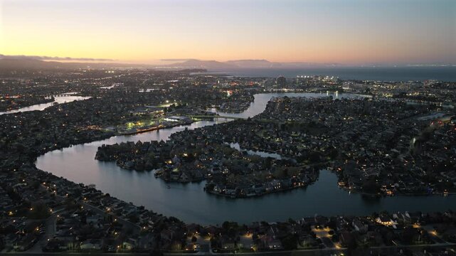Foster City CA - Aerial View of Foster City Waterways and Canals at Sunset with SF & Planes in Distance