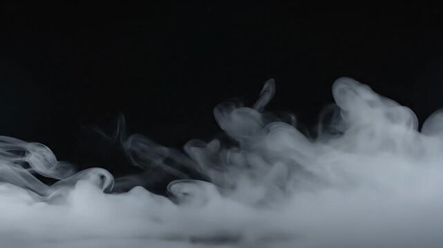 Wisps of white smoke gently drift across a dark background