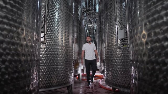Engineer technologist inspects and diagnoses equipment at a wine production plant 