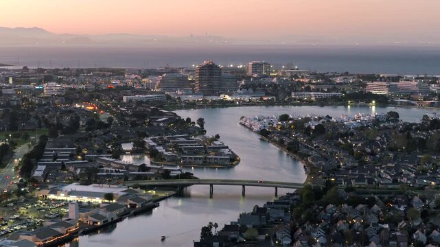 Foster City CA - Zoomed Aerial View of Waterway and Cars on Bridge at Dusk 
