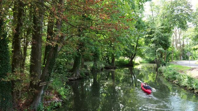 L&uuml;bbenau, Germany &ndash; Leisure kayaking on idyllic waterway between trees in the Spreewald. Suitable for sustainable tourism and recreation.