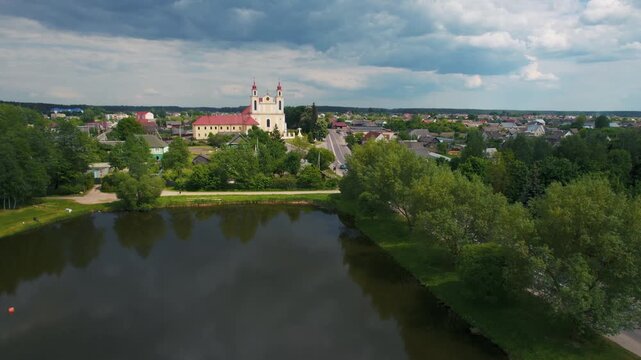 Aerial view of a historic church near a lake in a small european town