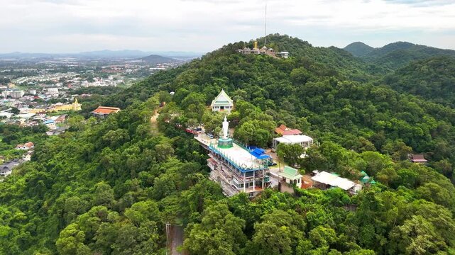 SI RACHA, THAILAND - MARCH 17, 2026: Aerial view of Samnaksong Khao Phra Khru Buddhist temple and monastery located on a hilltop overlooking the city.
