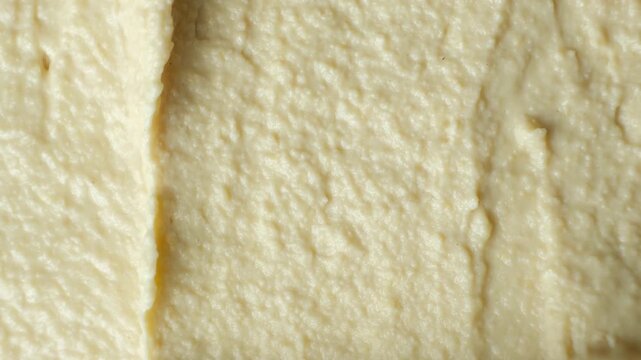 Macro texture of smooth creamy hummus top view