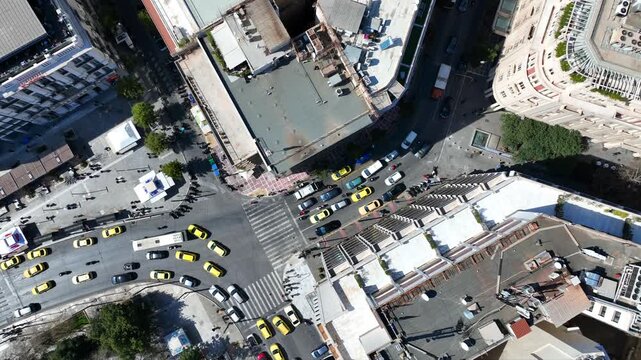 Aerial drone top down cinematic video of Athens centre dense urban landmark buildings near area of Syntagma square and Athens neoclassic trilogy in Panepistimiou street, Attica, Greece